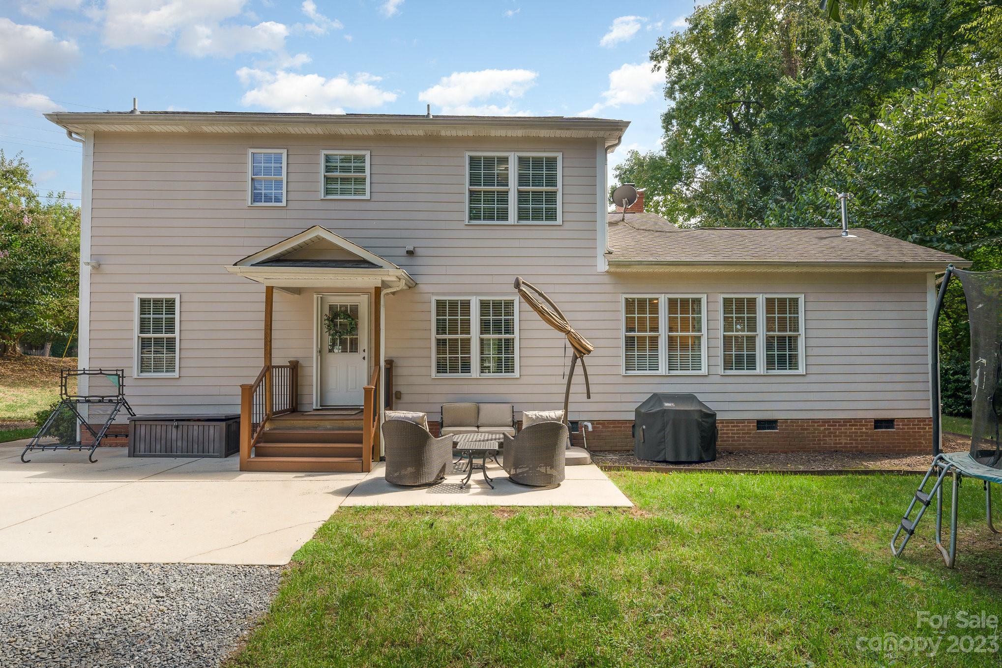 5816 Sharon Road Charlotte, NC 28210 - Photo 26 of 33 a view of a house with a yard and sitting area