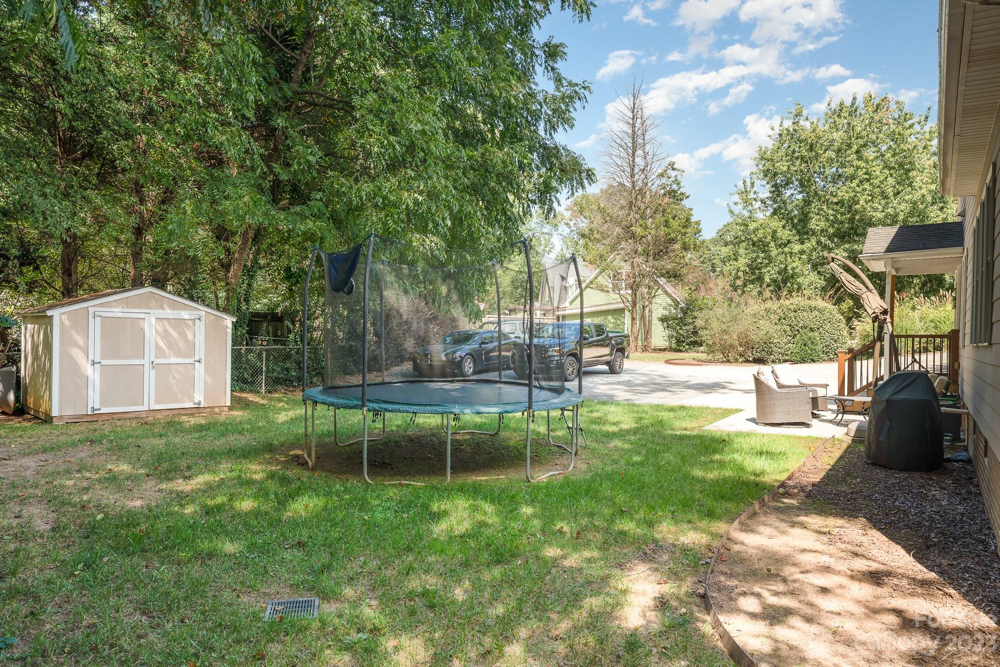 5816 Sharon Road Charlotte, NC 28210 - Photo 30 of 33 a view of a backyard with table and chairs potted plants and large tree