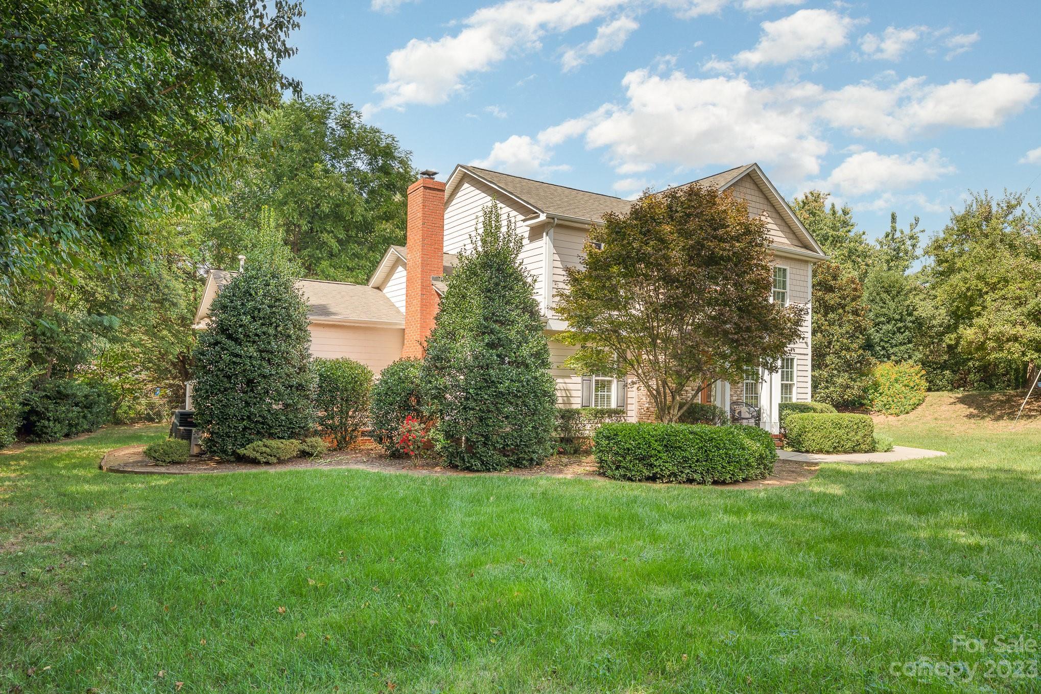5816 Sharon Road Charlotte, NC 28210 - Photo 31 of 33 a view of a house with a big yard and potted plants