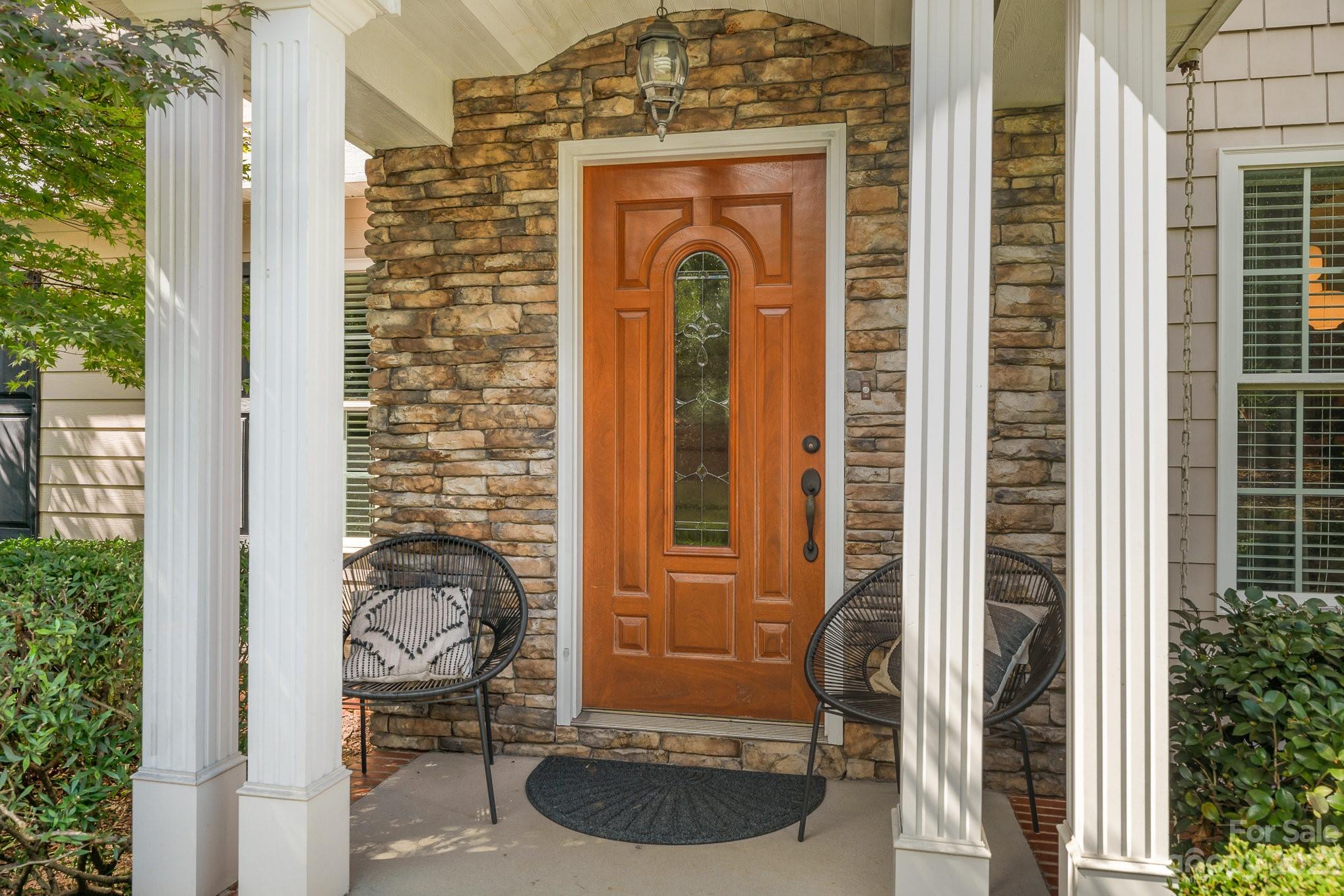 5816 Sharon Road Charlotte, NC 28210 - Photo 4 of 33 a front view of a house with a glass door