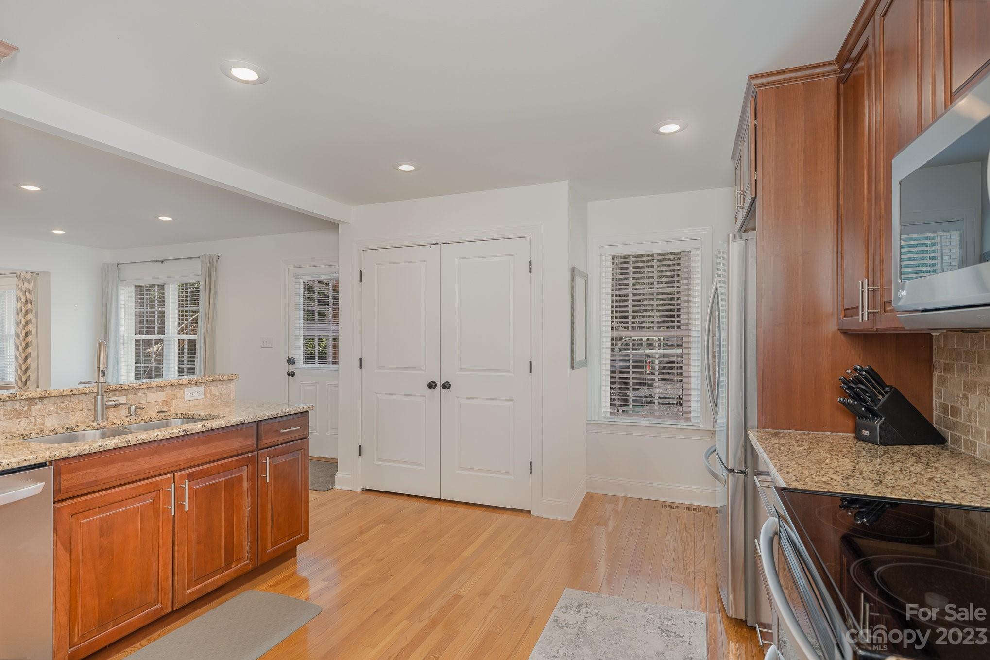 5816 Sharon Road Charlotte, NC 28210 - Photo 10 of 33 a kitchen with a sink stove and cabinets