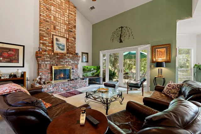 a living room with furniture and a large mirror