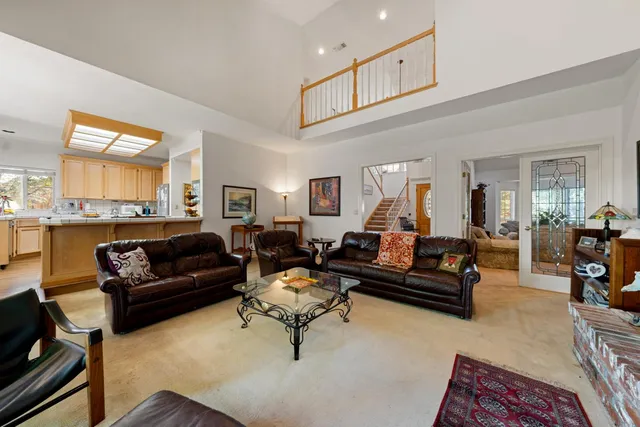 a living room with furniture a fireplace and a large window