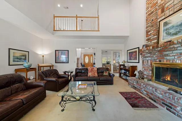 a view of a a dining room with furniture window and wooden floor