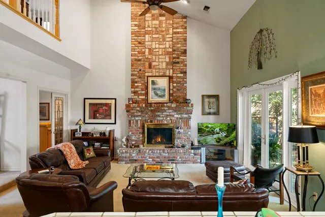 a bathroom with a granite countertop sink a toilet a mirror a vanity and shower