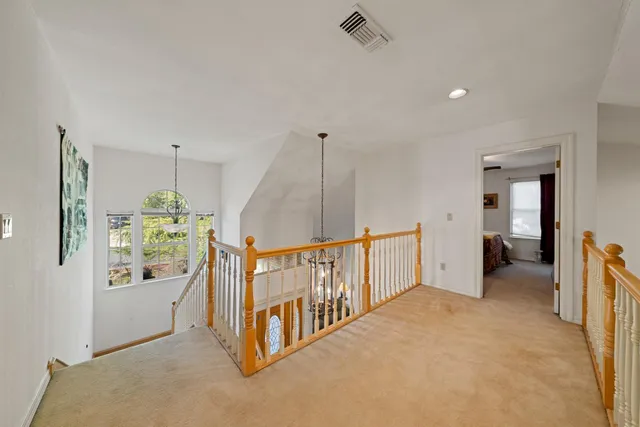 a large kitchen with kitchen island a large counter space a sink stainless steel appliances and cabinets