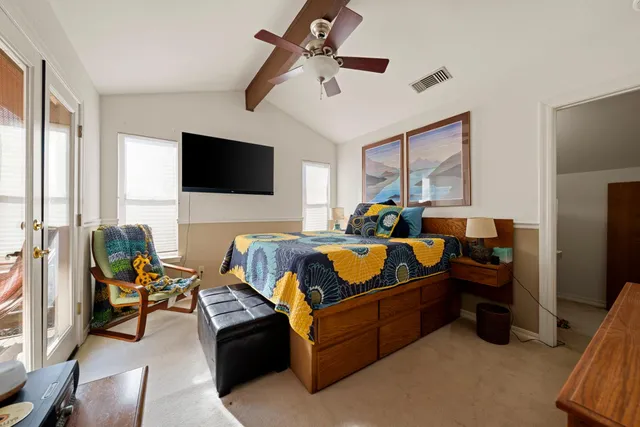 a view of table and chairs under an umbrella