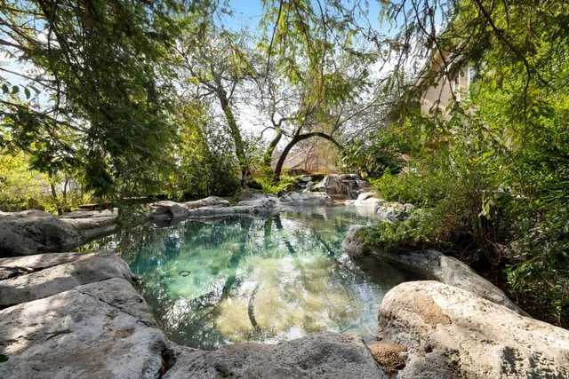 an aerial view of a house with yard and outdoor seating