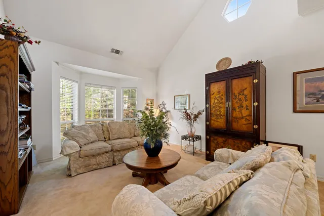 a living room with furniture a bookshelf and a book shelf