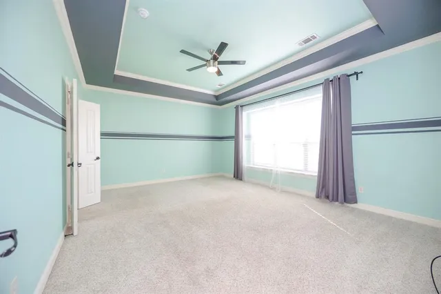 a view of a livingroom with a ceiling fan and window