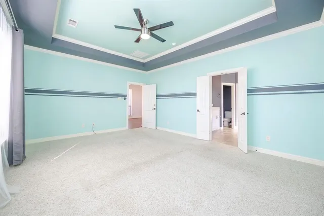 a view of a livingroom with a ceiling fan and entryway