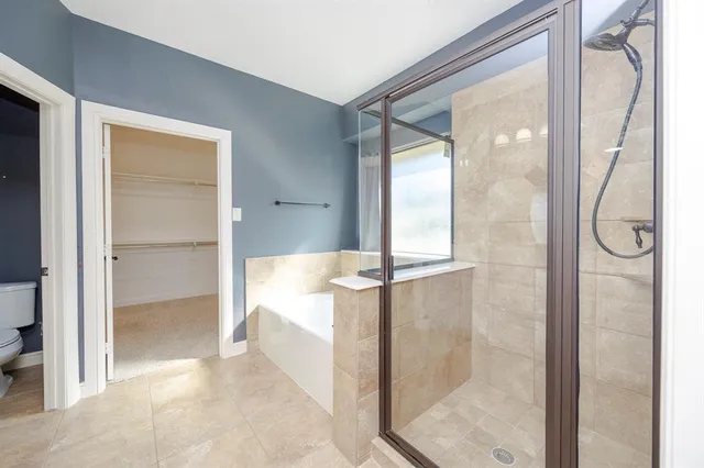 a bathroom with a glass shower door and a mirror