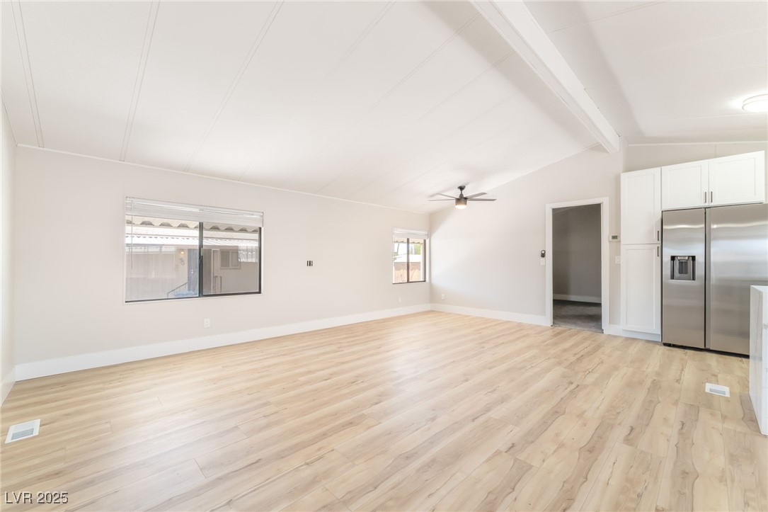 5552 Aldama Road Las Vegas, NV 89122 - Photo 12 of 35 Unfurnished living room featuring light wood-style