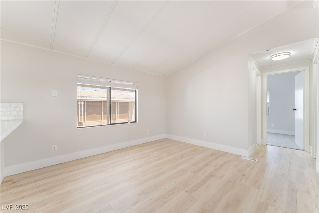 5552 Aldama Road Las Vegas, NV 89122 - Photo 16 of 35 Spare room with light wood finished floors and bas