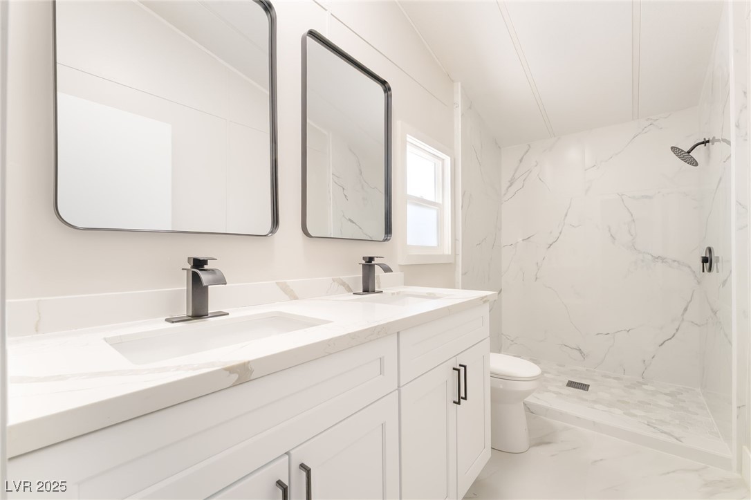 5552 Aldama Road Las Vegas, NV 89122 - Photo 18 of 35 Full bathroom with double vanity, a marble finish