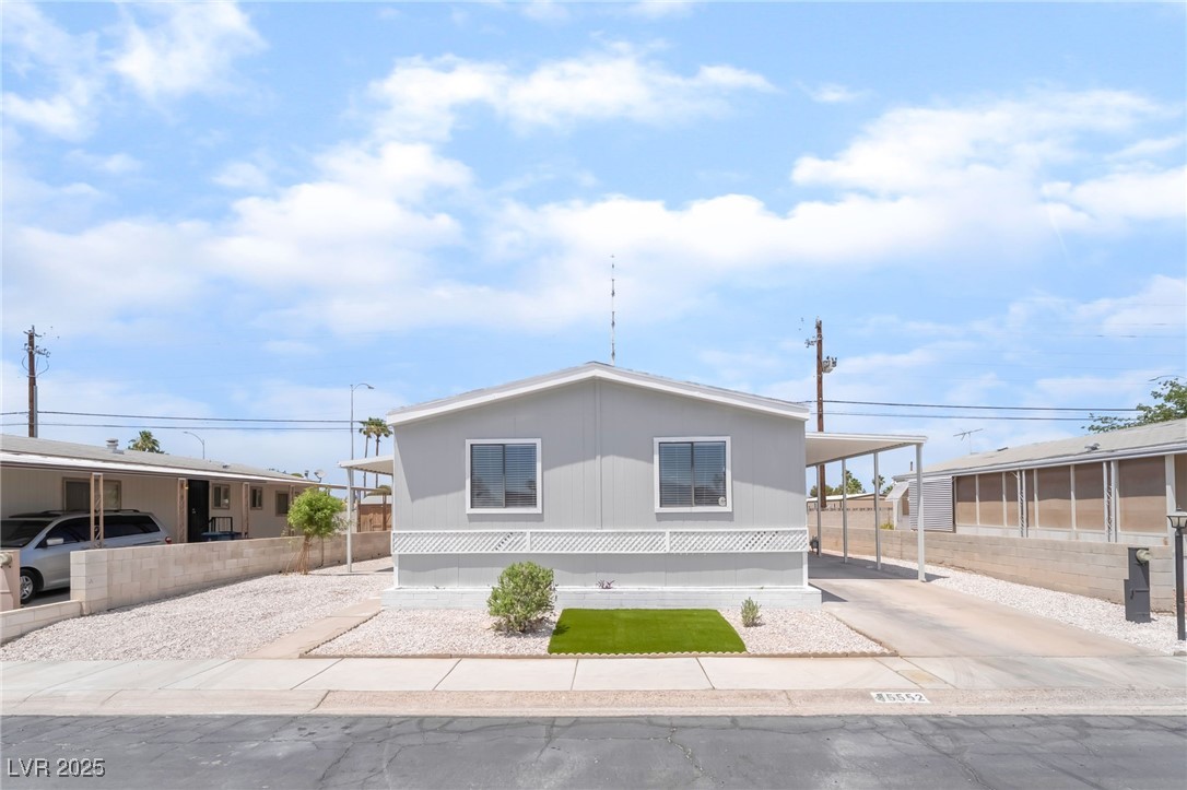 5552 Aldama Road Las Vegas, NV 89122 - Photo 2 of 35 Manufactured / mobile home with driveway and a car