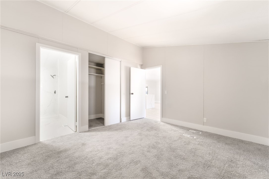 5552 Aldama Road Las Vegas, NV 89122 - Photo 23 of 35 Unfurnished bedroom with carpet flooring, a closet