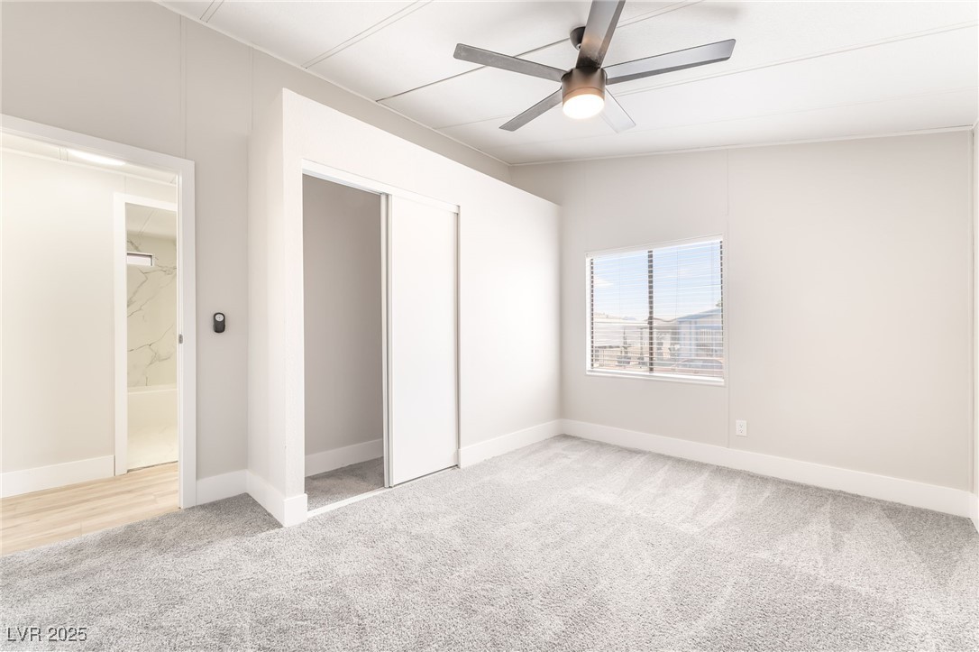5552 Aldama Road Las Vegas, NV 89122 - Photo 26 of 35 Unfurnished bedroom with light colored carpet, a c