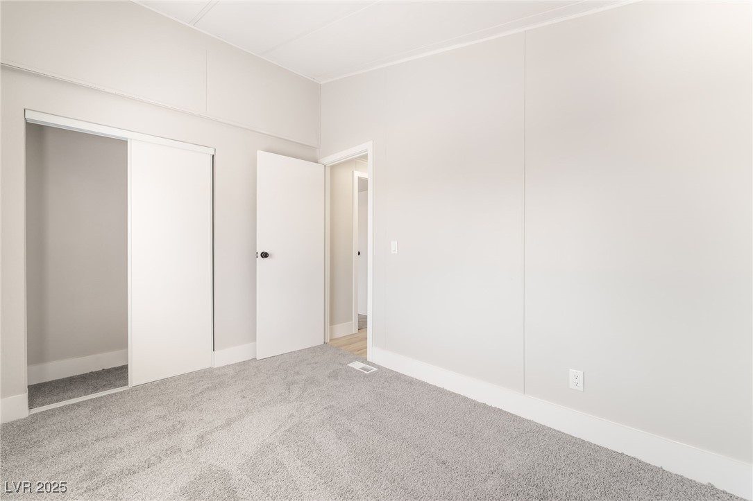 5552 Aldama Road Las Vegas, NV 89122 - Photo 28 of 35 Unfurnished bedroom with carpet flooring and a clo