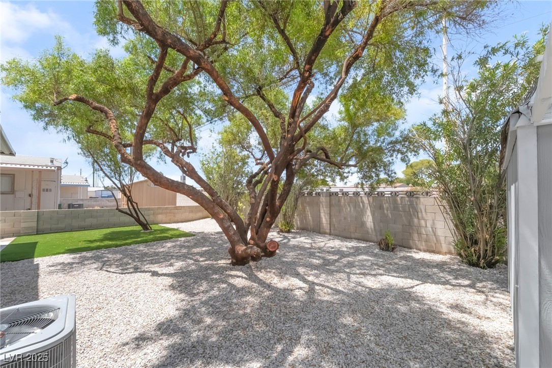 5552 Aldama Road Las Vegas, NV 89122 - Photo 32 of 35 Fenced backyard featuring a patio