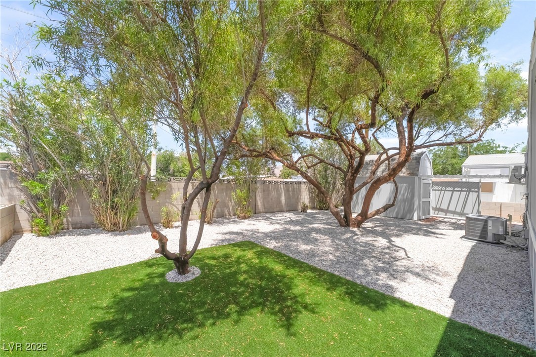 5552 Aldama Road Las Vegas, NV 89122 - Photo 6 of 35 Fenced backyard featuring a patio area