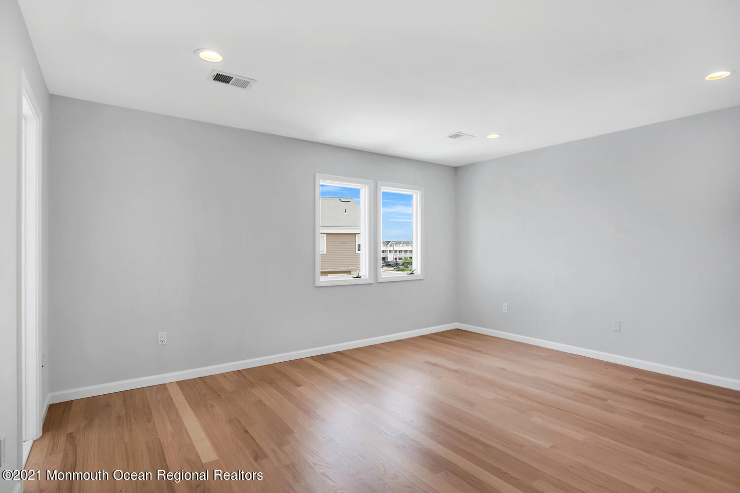 1332 Ocean Avenue, Unit 5R Sea Bright, NJ 07760 - Photo 15 of 40 a view of an empty room with wooden floor and a window