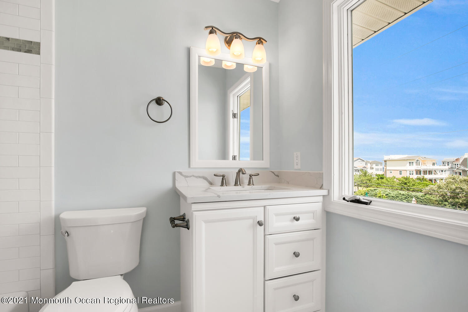 1332 Ocean Avenue, Unit 5R Sea Bright, NJ 07760 - Photo 16 of 40 a bathroom with a granite countertop toilet a sink and a large mirror