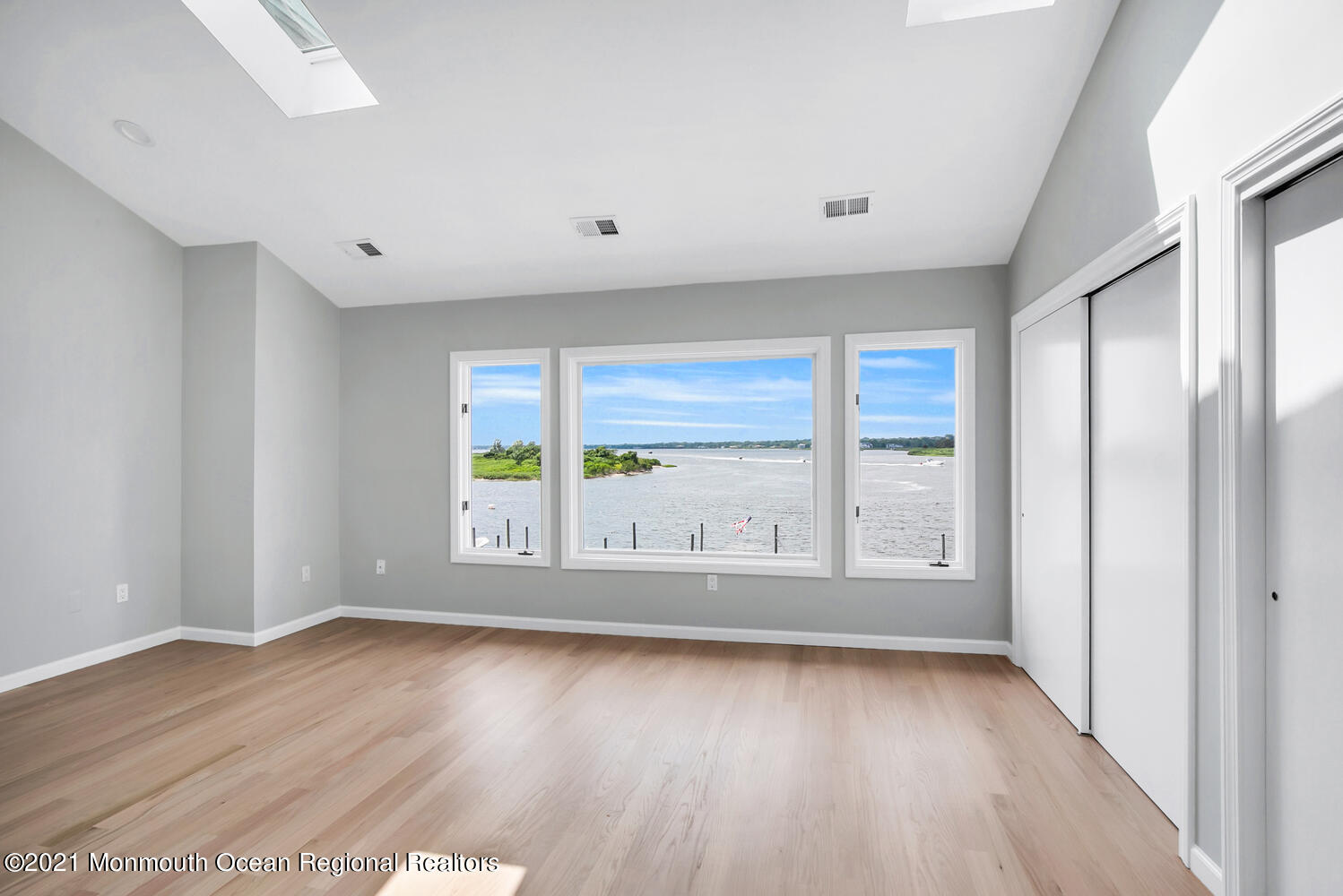 1332 Ocean Avenue, Unit 5R Sea Bright, NJ 07760 - Photo 19 of 40 a view of an empty room with wooden floor and a window