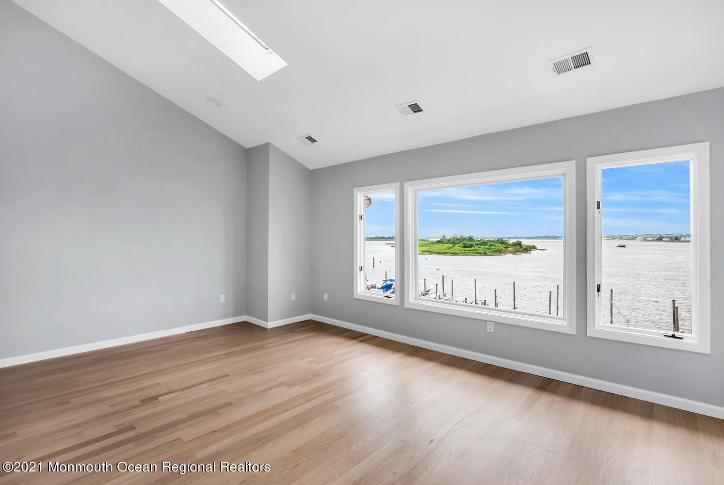 1332 Ocean Avenue, Unit 5R Sea Bright, NJ 07760 - Photo 20 of 40 a view of an empty room with wooden floor and a window