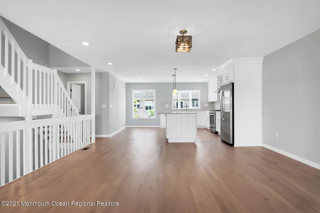 a view of a kitchen with wooden floor and a sink
