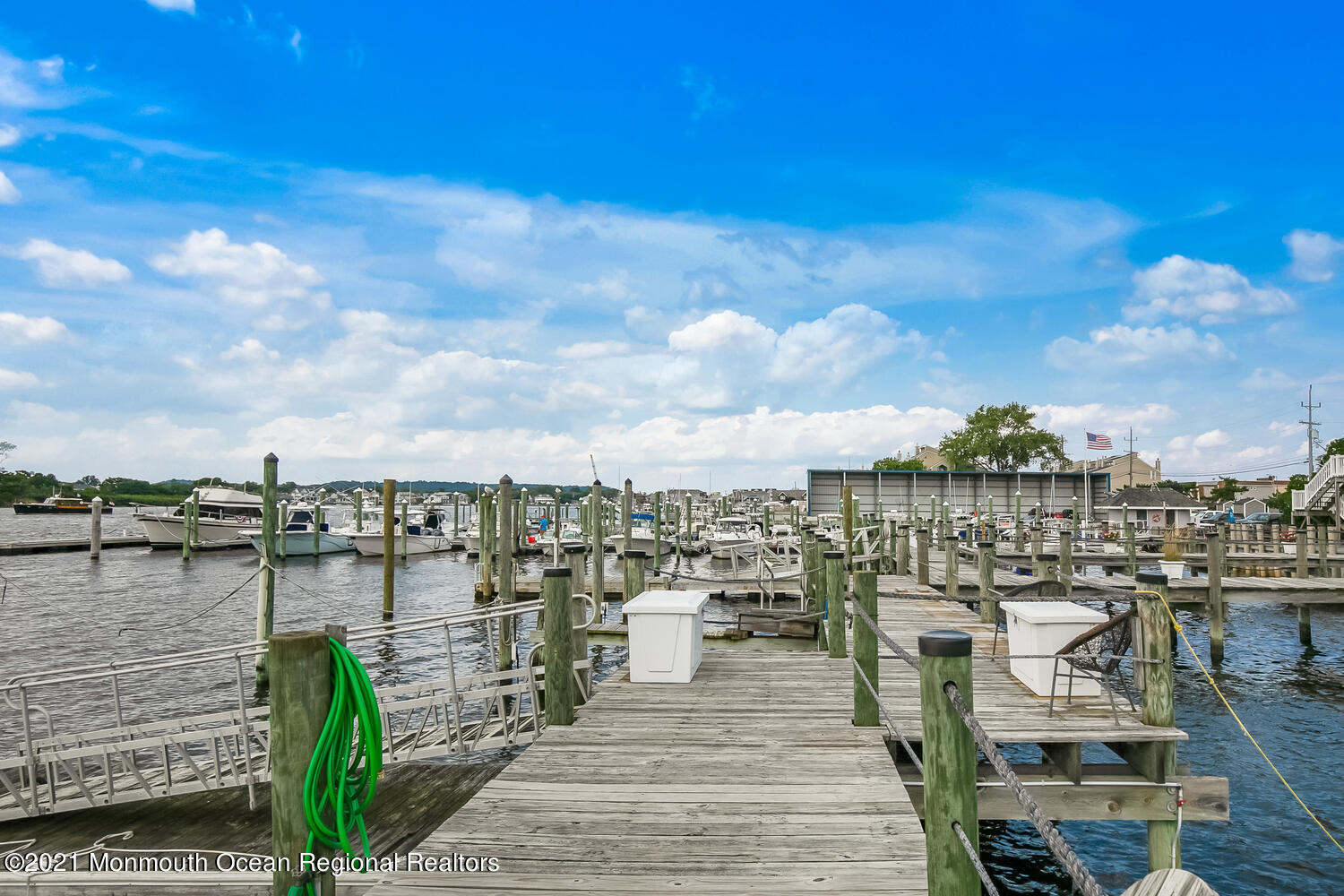 1332 Ocean Avenue, Unit 5R Sea Bright, NJ 07760 - Photo 33 of 40 a view of a lake with boats and trees in the background