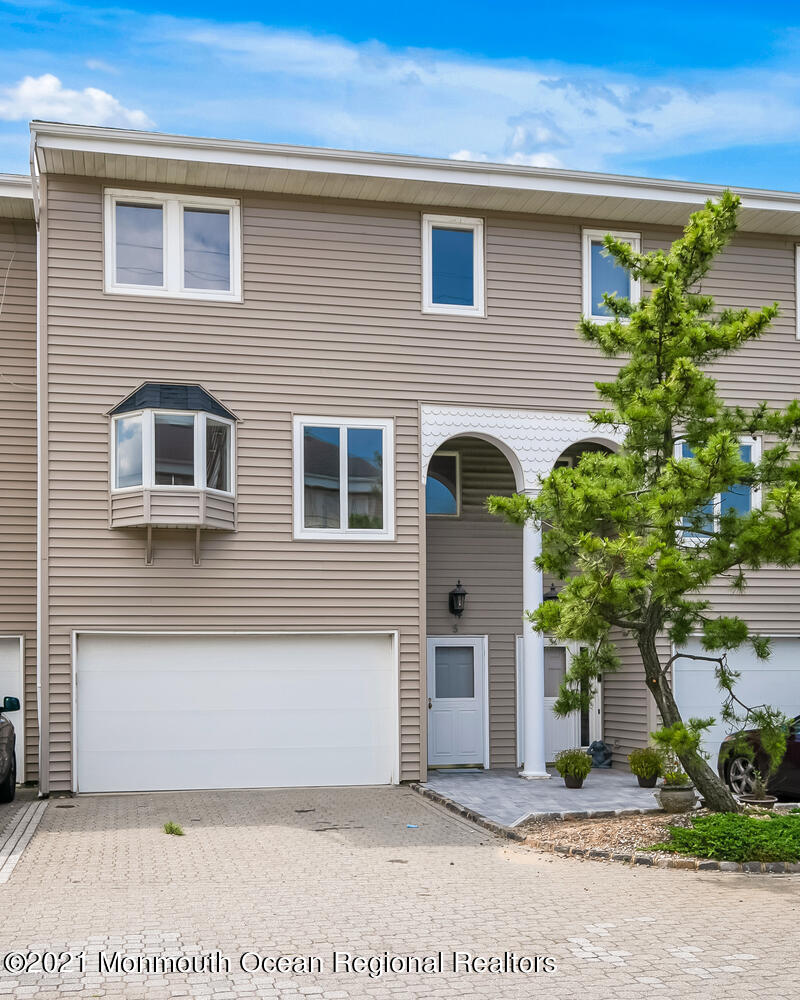 1332 Ocean Avenue, Unit 5R Sea Bright, NJ 07760 - Photo 36 of 40 a front view of a house with plants