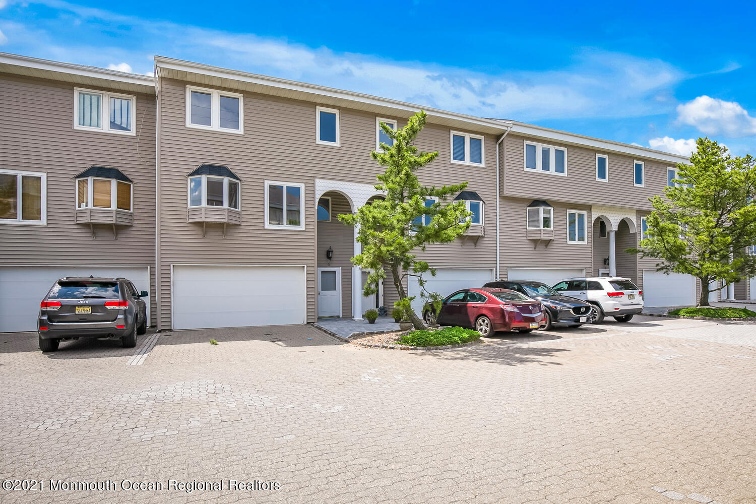 1332 Ocean Avenue, Unit 5R Sea Bright, NJ 07760 - Photo 38 of 40 a view of a car in front of a white house