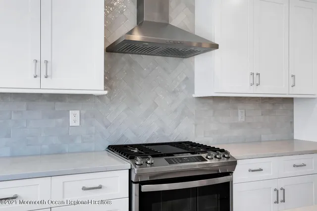 a stove top oven sitting inside of a kitchen