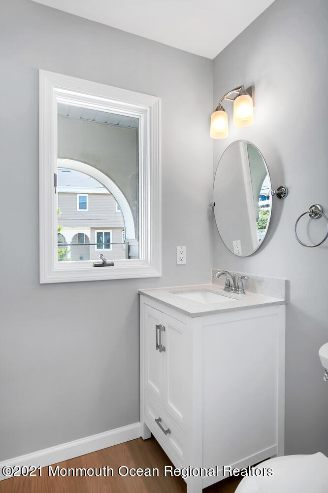 1332 Ocean Avenue, Unit 5R Sea Bright, NJ 07760 - Photo 10 of 40 a bathroom with a sink a mirror and vanity
