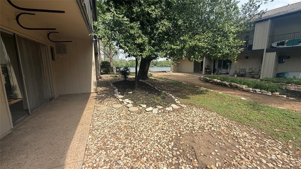 500 East Riverside Drive, Unit 132 Austin, TX 78704 - Photo 18 of 31 a view of a yard with a tree in front of a house