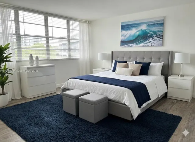 a bedroom with a bed and a large window