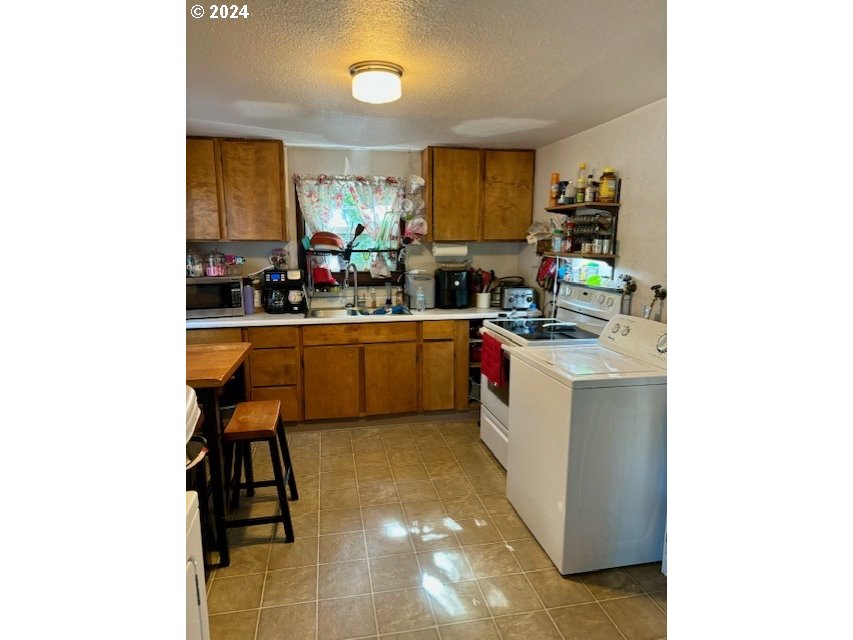 517 1/2 Southwest 13th Street Pendleton, OR 97801 - Photo 4 of 9 a kitchen with a sink cabinets and window