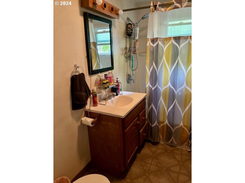 517 1/2 Southwest 13th Street Pendleton, OR 97801 - Photo 7 of 9 a bathroom with a sink toilet and mirror