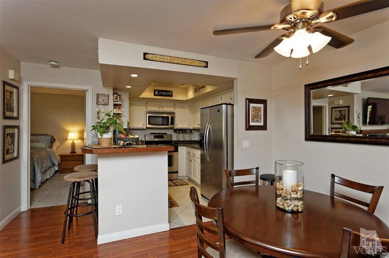 1007 Waltham Road, Unit F Simi Valley, CA 93065 - Photo 16 of 32 a kitchen with stainless steel appliances granite countertop a dining table cabinets and wooden floor