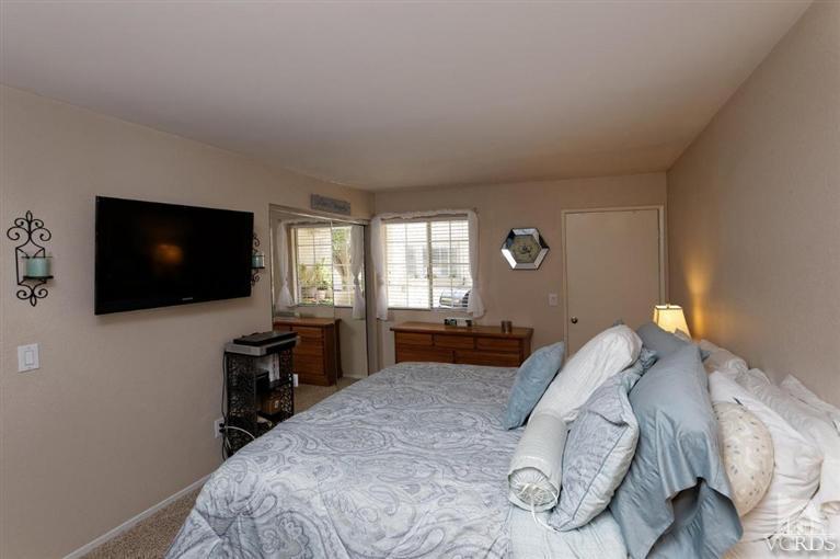 1007 Waltham Road, Unit F Simi Valley, CA 93065 - Photo 20 of 32 a bedroom with a bed and a flat screen tv