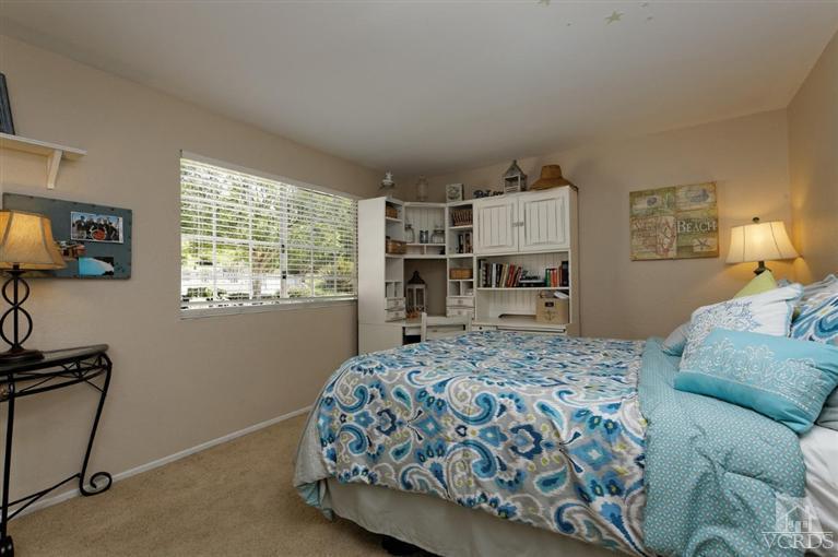 1007 Waltham Road, Unit F Simi Valley, CA 93065 - Photo 24 of 32 a bedroom with a bed and a tv in it