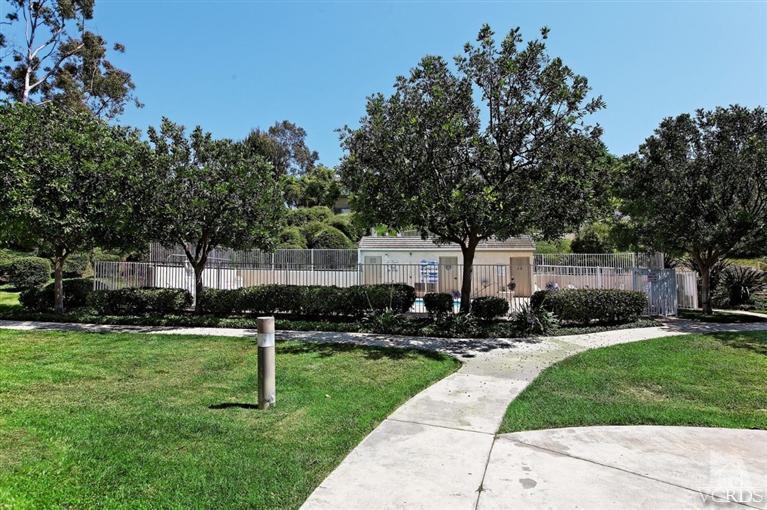 1007 Waltham Road, Unit F Simi Valley, CA 93065 - Photo 26 of 32 a front view of a house with a yard and tree