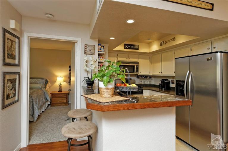 1007 Waltham Road, Unit F Simi Valley, CA 93065 - Photo 5 of 32 a kitchen with stainless steel appliances a sink a refrigerator a counter top space and cabinets