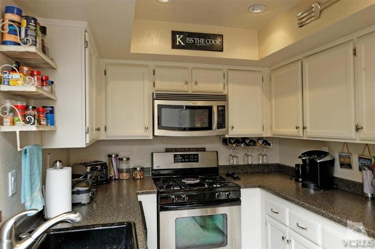1007 Waltham Road, Unit F Simi Valley, CA 93065 - Photo 9 of 32 a kitchen with stainless steel appliances granite countertop a stove a sink and a white cabinets