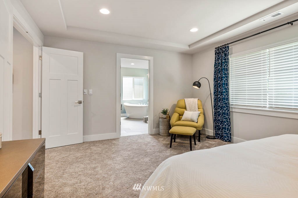 22816 22nd Avenue West, Unit EP 19 Bothell, WA 98021 - Photo 9 of 27 a bedroom with a bed and chair