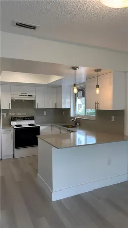 a kitchen with stainless steel appliances granite countertop a stove and a sink