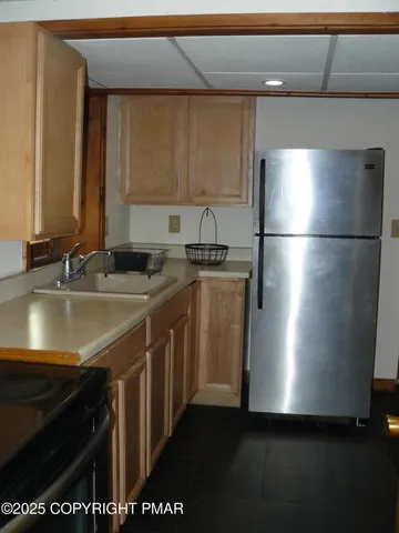 a kitchen with stainless steel appliances a sink cabinets and a counter
