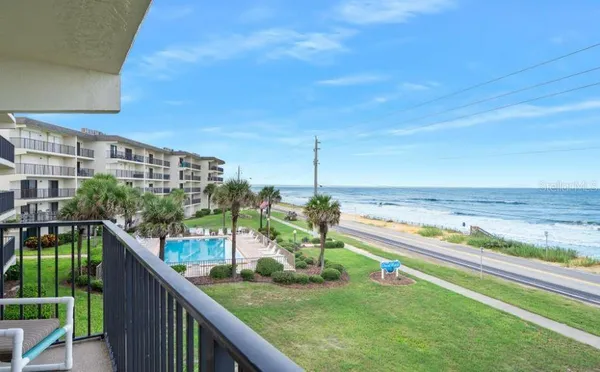 a view of a balcony with an ocean view