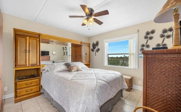 a bedroom with a bed and a painting on the wall